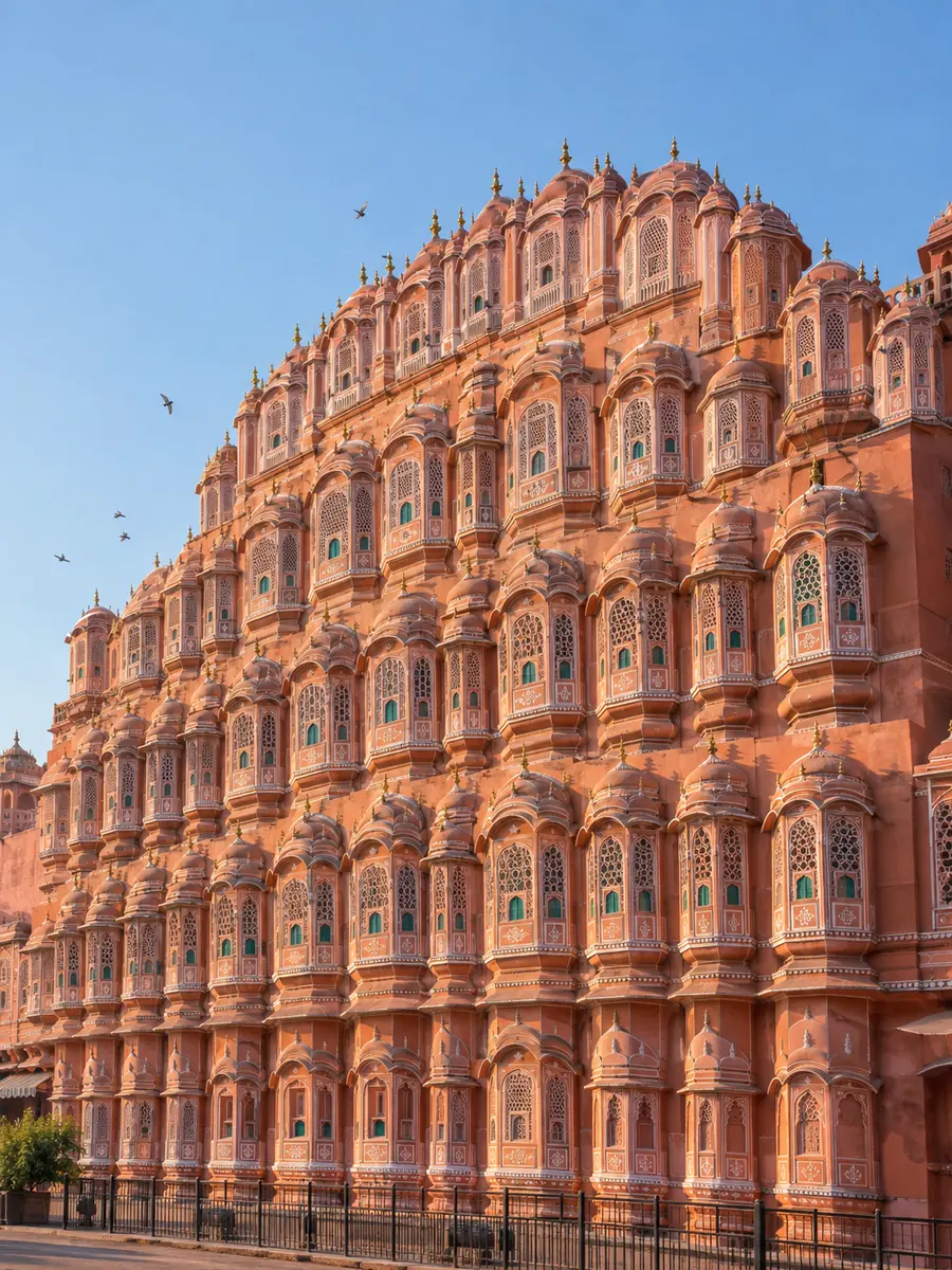 The pink latticed facade of Hawa Mahal in Jaipur in morning sun