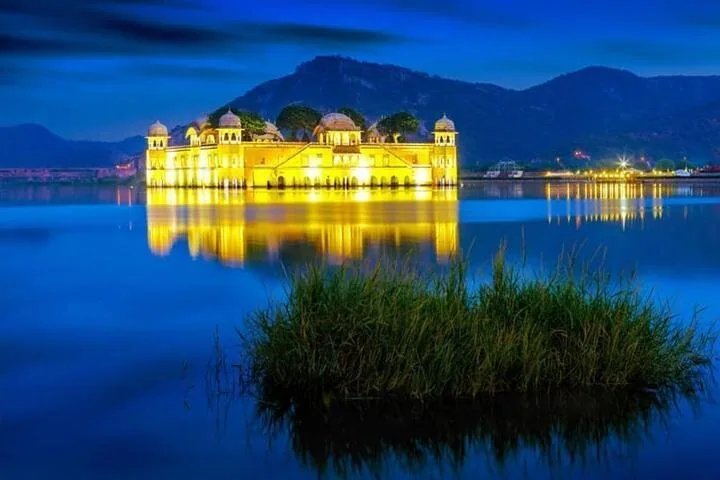 Jal Mahal lit up gold on Man Sagar Lake at dusk